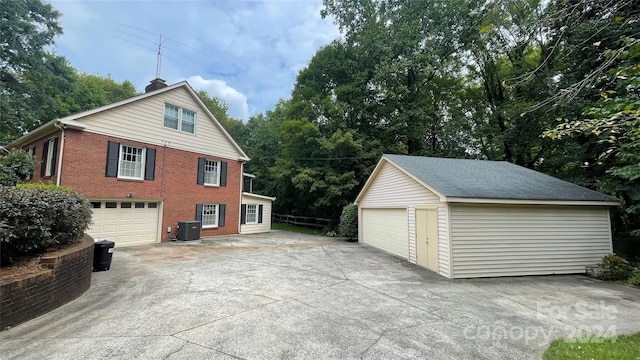 view of home's exterior featuring central AC unit and a garage