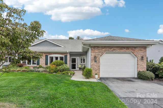 single story home with a garage and a front yard