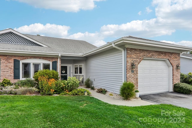 23 Country Meadows Ln, Hendersonville, NC 28792 - view of home's exterior with an attached garage, a lawn, aphalt driveway, and brick siding