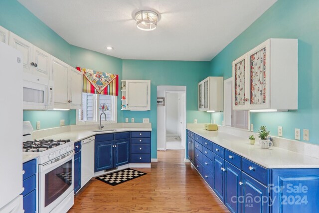 23 Country Meadows Ln, Hendersonville, NC 28792 - kitchen with white cabinets, a sink, white appliances, light wood-style floors, and blue cabinets