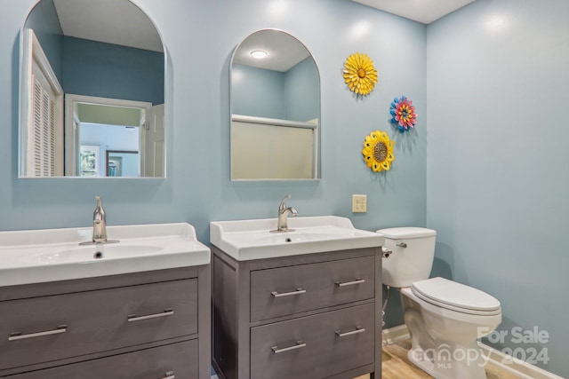 23 Country Meadows Ln, Hendersonville, NC 28792 - full bath featuring two vanities, an enclosed shower, a sink, and toilet