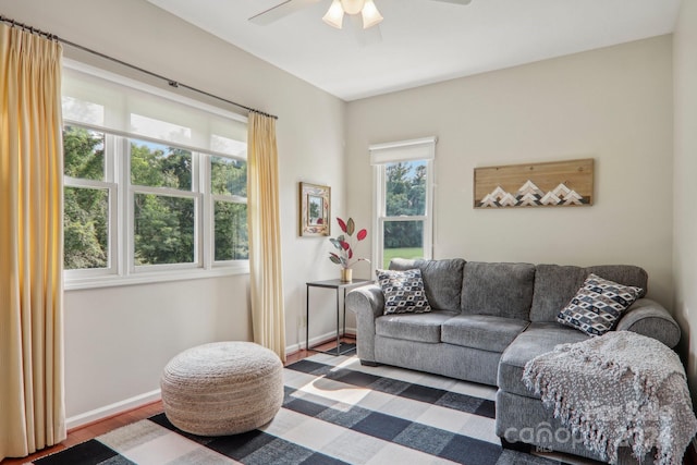 living room with ceiling fan, a wealth of natural light, and wood-type flooring