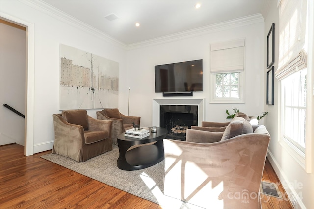 living room featuring ornamental molding and wood-type flooring