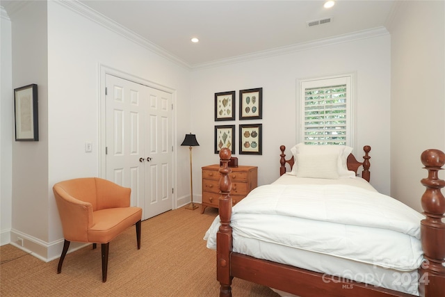 bedroom featuring light colored carpet, a closet, and crown molding