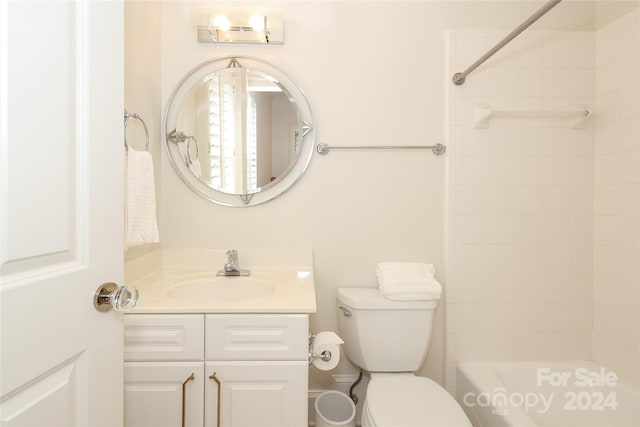 full bathroom with tiled shower / bath, toilet, and vanity