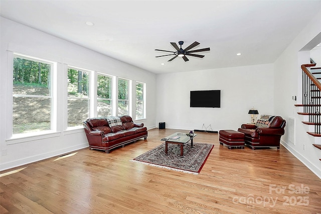 living room featuring ceiling fan and light wood-type flooring