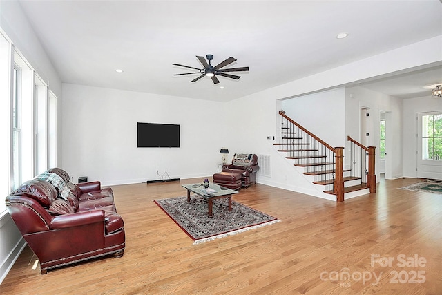 living room featuring hardwood / wood-style floors and ceiling fan