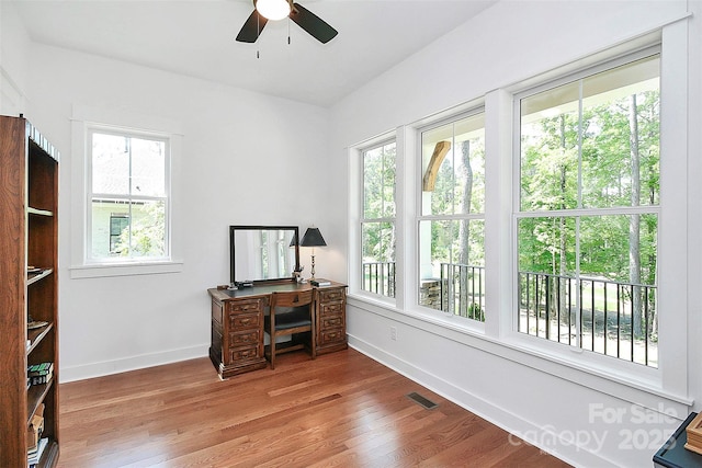 home office featuring ceiling fan, hardwood / wood-style floors, and a wealth of natural light