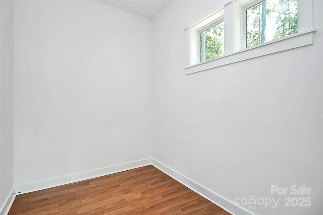 unfurnished room featuring wood-type flooring