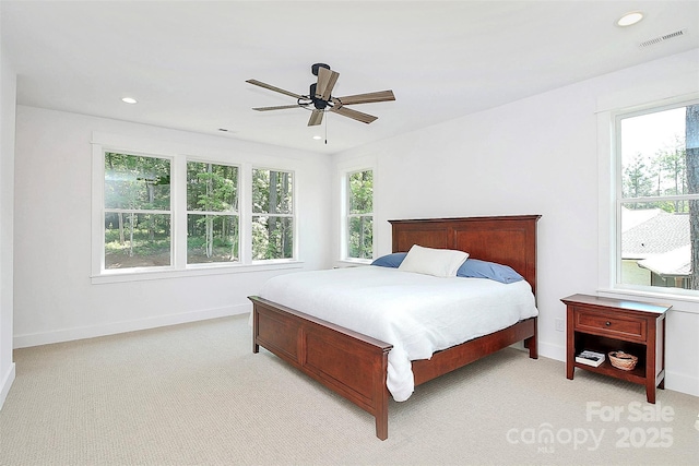 bedroom featuring light colored carpet and ceiling fan