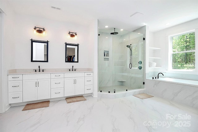 bathroom with vanity and independent shower and bath