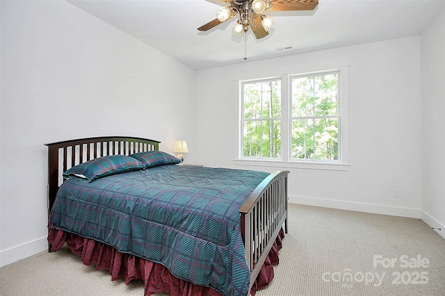 bedroom featuring ceiling fan and light carpet