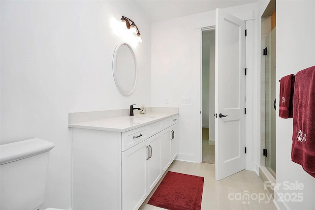 bathroom with vanity and a shower with shower door