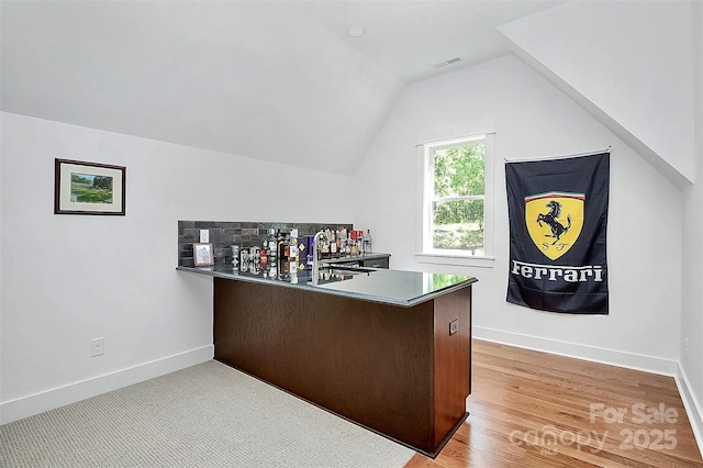 office area with lofted ceiling, sink, and light hardwood / wood-style flooring