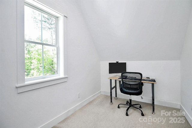 office with lofted ceiling and light carpet