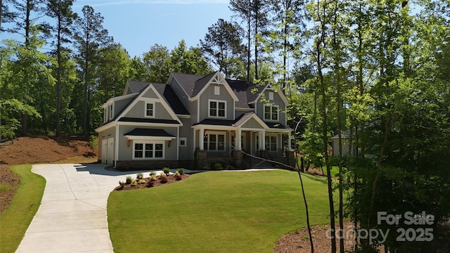 craftsman inspired home with a garage and a front yard