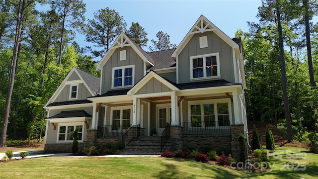 craftsman-style home featuring a front yard and covered porch