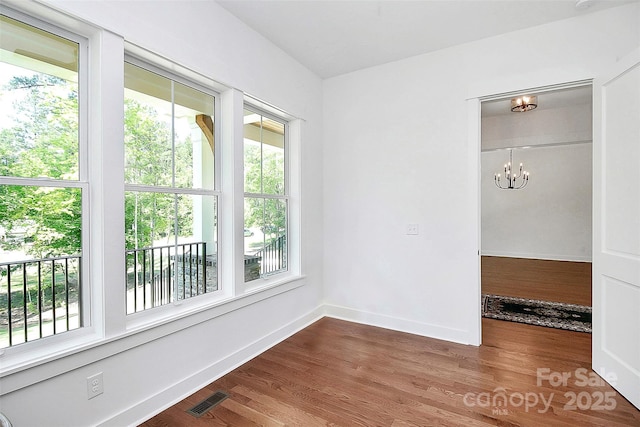 6178 Chimney Bluff Rd, Lancaster, SC 29720 - spare room with wood finished floors, baseboards, a chandelier, and visible vents
