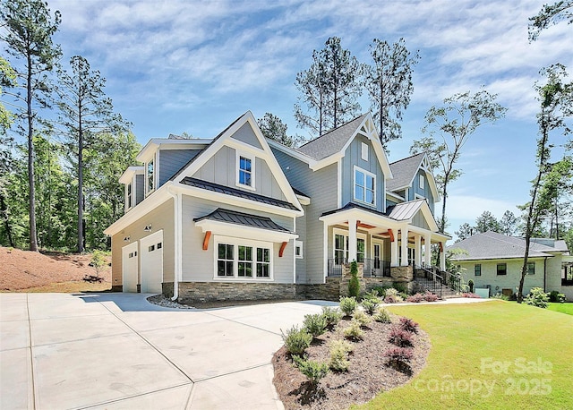 6178 Chimney Bluff Rd, Lancaster, SC 29720 - view of front of property featuring a standing seam roof, concrete driveway, board and batten siding, a front lawn, and metal roof