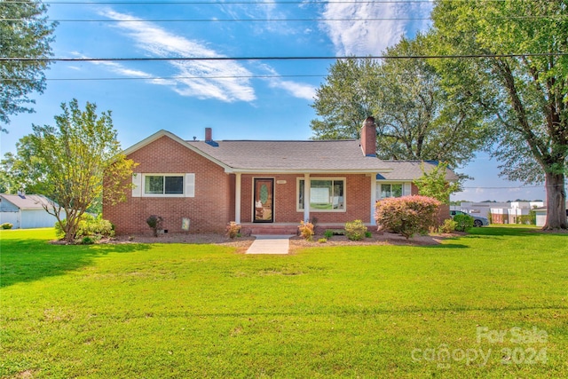 ranch-style home with a front lawn