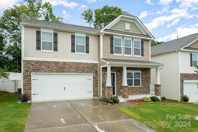 craftsman-style home featuring a garage and a front lawn