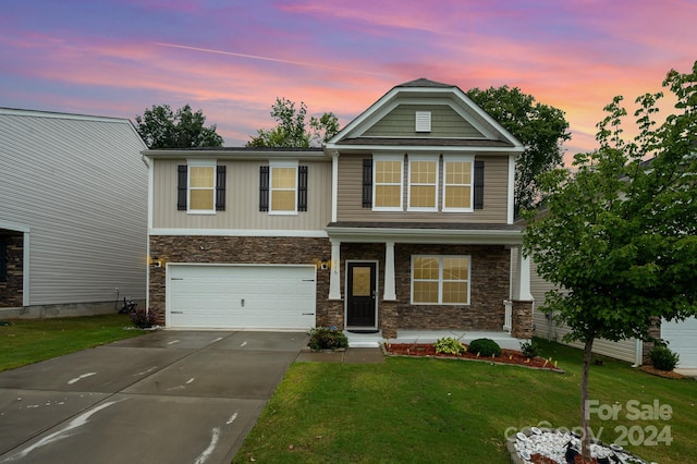 craftsman-style home with a garage and a yard