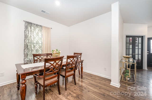 dining space with dark wood-type flooring and french doors