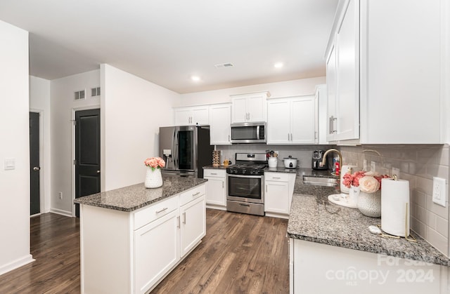 kitchen with sink, white cabinets, appliances with stainless steel finishes, and dark wood-type flooring