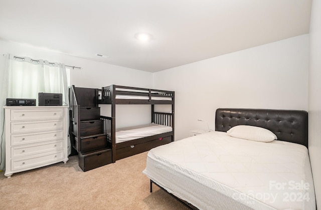 bedroom featuring light colored carpet