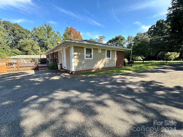 view of property exterior featuring a deck