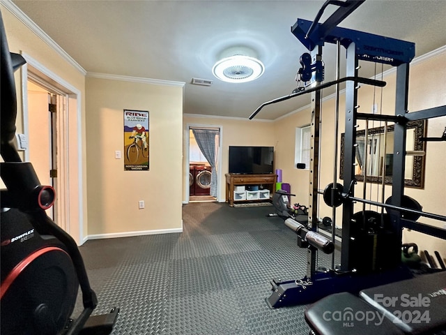 workout area featuring ornamental molding