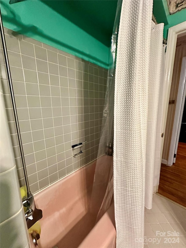 bathroom featuring shower / tub combo with curtain and wood-type flooring