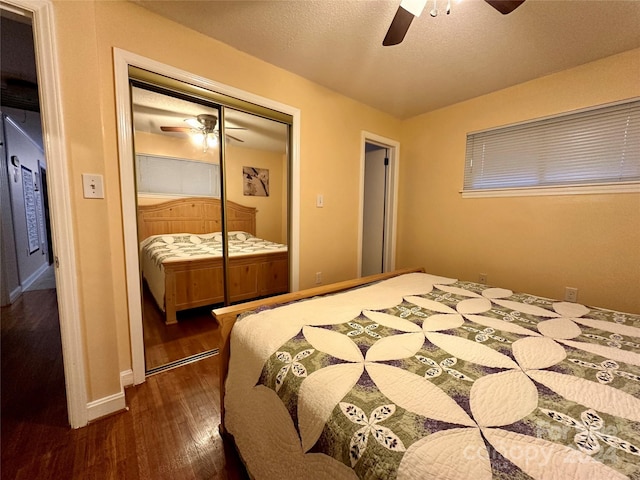 bedroom with a closet, ceiling fan, dark hardwood / wood-style flooring, and a textured ceiling