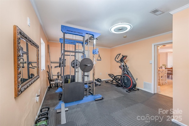 workout room with visible vents, baseboards, and crown molding