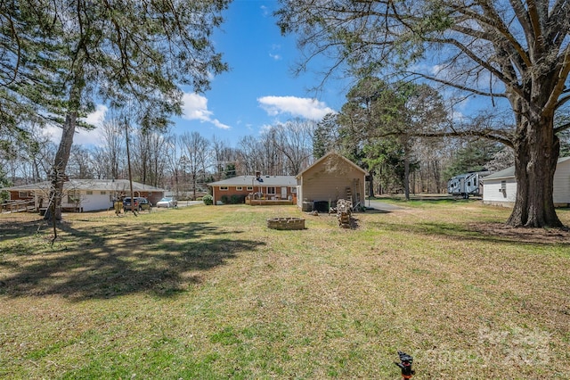 view of yard featuring a fire pit