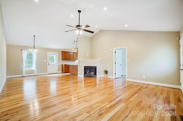 unfurnished living room with light hardwood / wood-style floors, high vaulted ceiling, and ceiling fan