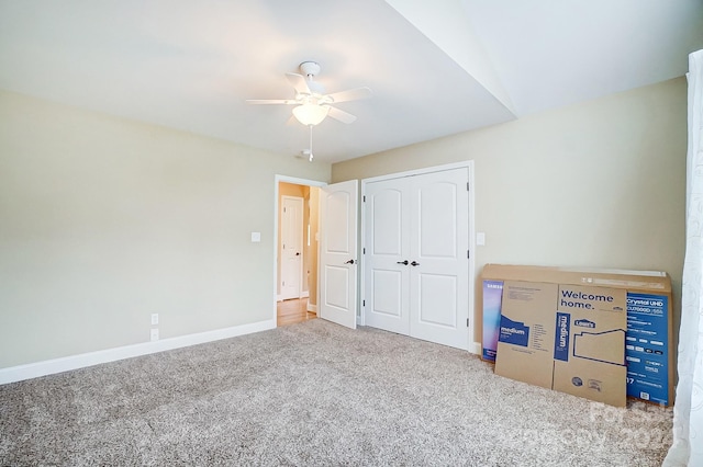 unfurnished bedroom with a closet, ceiling fan, and carpet flooring