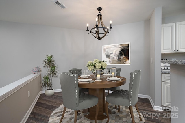 dining area featuring a chandelier and dark hardwood / wood-style flooring