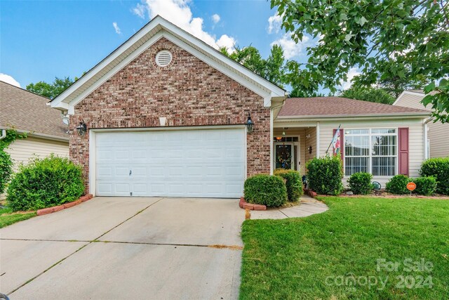 view of front of home with a garage and a front yard