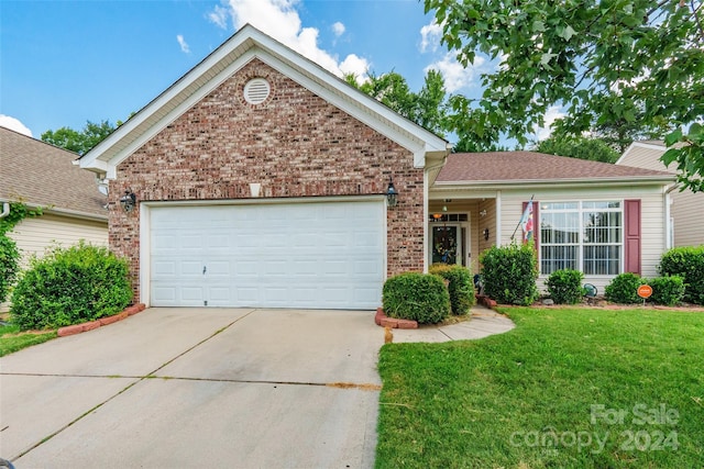 view of front of house featuring a garage and a front lawn