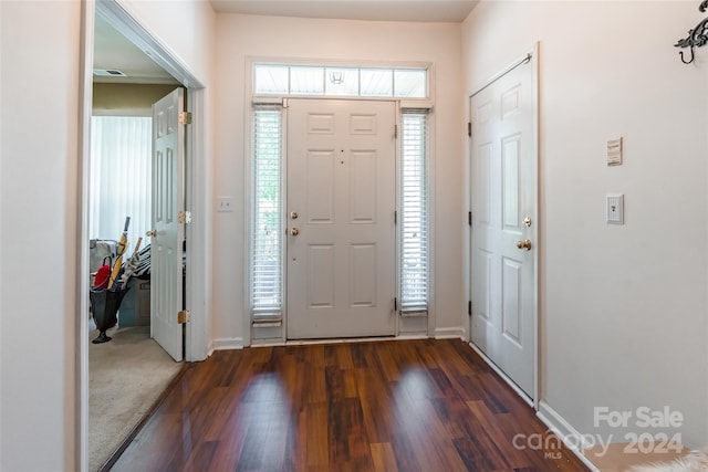 foyer with dark colored carpet