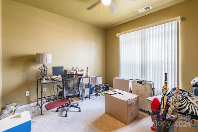 carpeted home office with ceiling fan