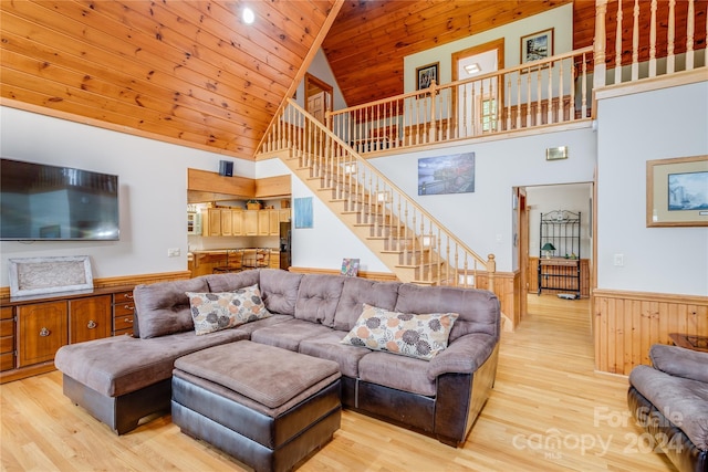 living room featuring light hardwood / wood-style floors, high vaulted ceiling, and wooden ceiling