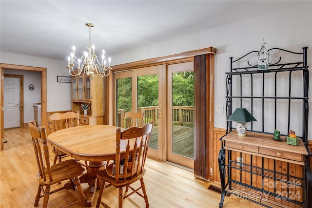 dining room featuring a notable chandelier and light hardwood / wood-style flooring