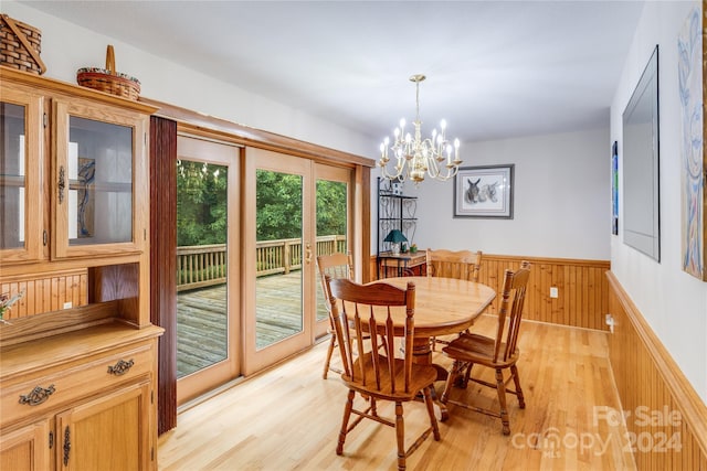 dining space featuring a notable chandelier and light hardwood / wood-style floors