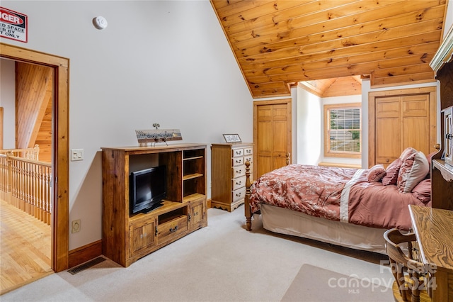 carpeted bedroom featuring wood walls, lofted ceiling, and wooden ceiling