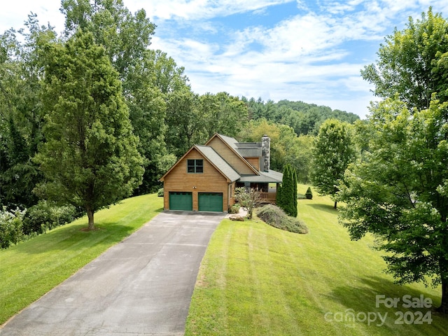 view of front of property with a garage and a front yard