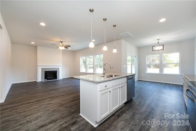 kitchen with dark wood-type flooring, sink, stainless steel appliances, hanging light fixtures, and white cabinetry