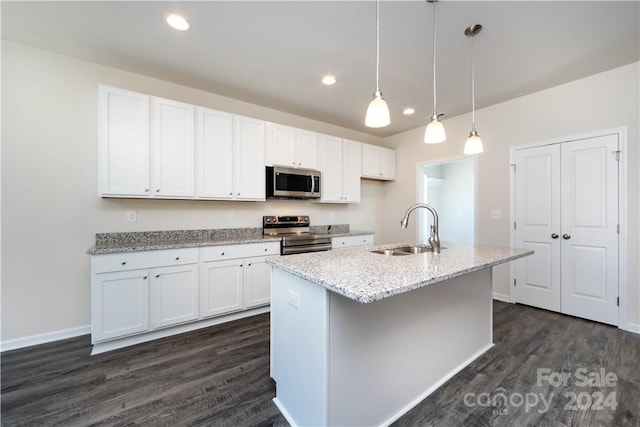 kitchen featuring an island with sink, white cabinets, appliances with stainless steel finishes, and sink