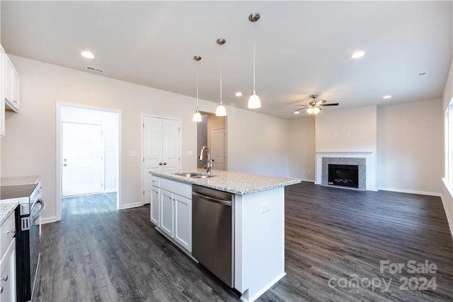 kitchen with stainless steel appliances, white cabinets, sink, dark hardwood / wood-style flooring, and decorative light fixtures